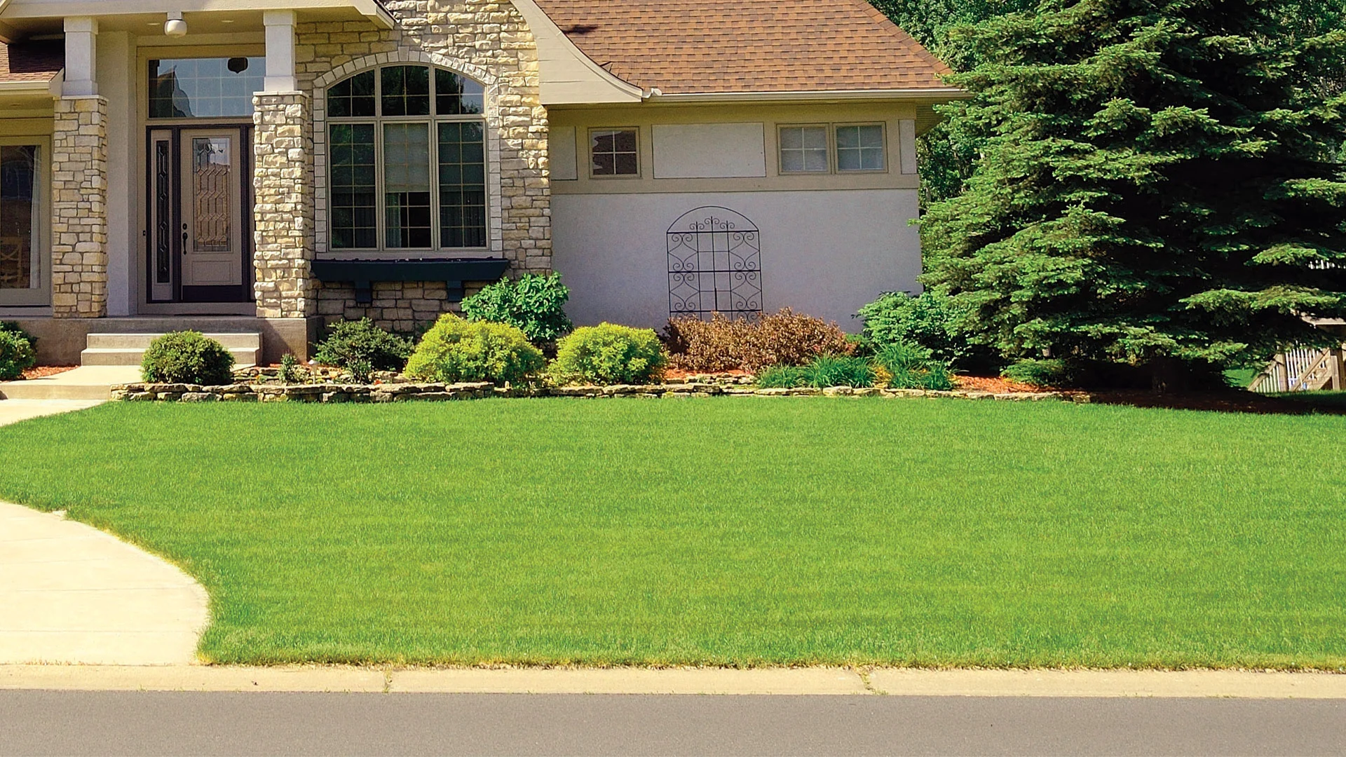 Landscape worker in Ada, MI holding fertilizer in hands.