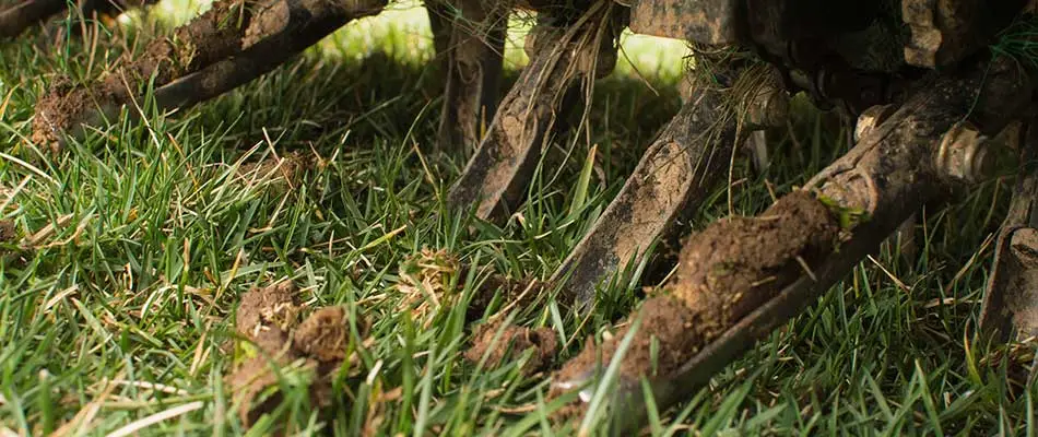 Lawn being aerated by a machine in Ada, MI.