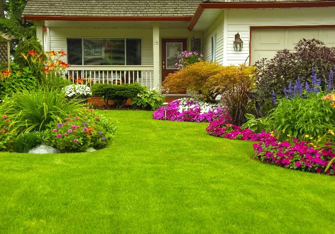 Colorful garden with bright flowers and lush lawn in Ada, MI.